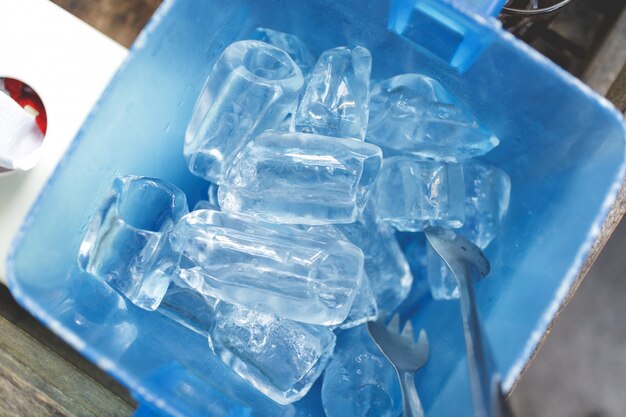 Ice cube in blue plastic basket. Thai restaurant serving style.