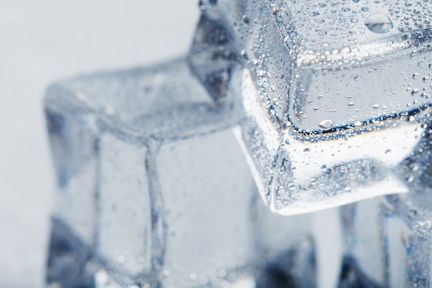 Ice cube with water drops close - up in macro Refreshing ice. Isolate