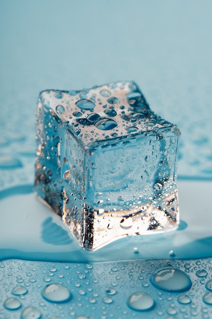 Ice cube with water drops. The ice is melting.