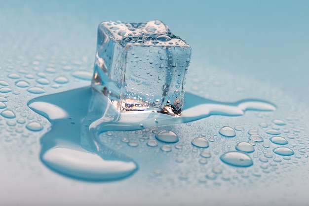 Ice cube with water drops. The ice is melting.