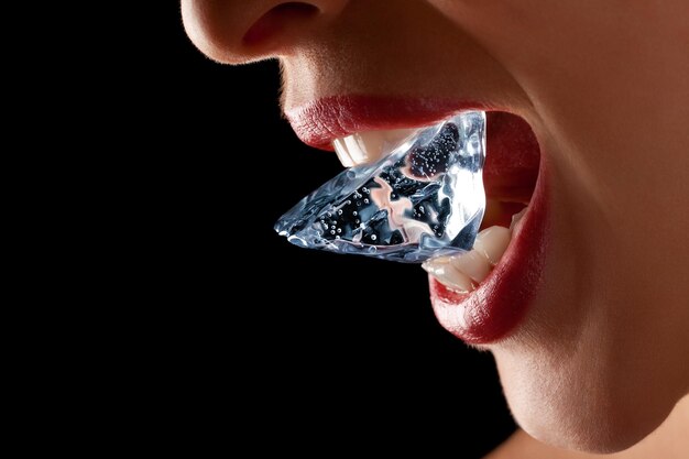 Photo ice cube in woman's mouth