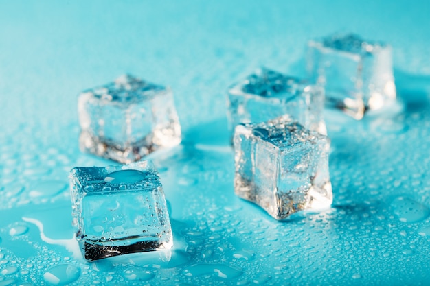 Ice cubes are scattered with water drops scattered