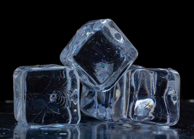 Ice cubes on a black background. ice cubes stacked pyramid