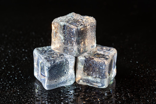 Ice cubes on black table background