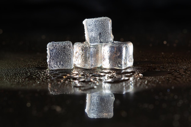 Ice cubes on black table background