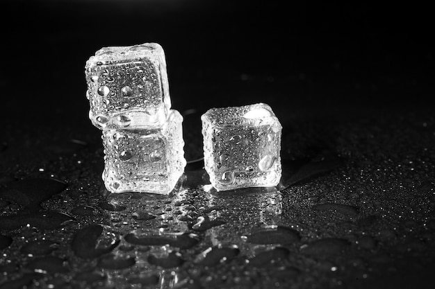 Ice cubes on black table