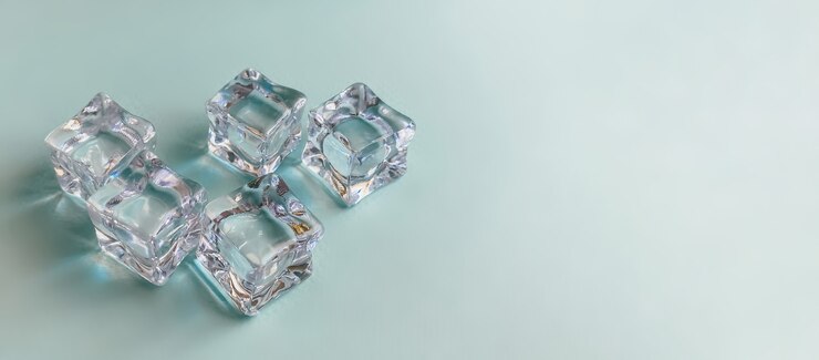 Ice cubes on a bright blue background summer concept