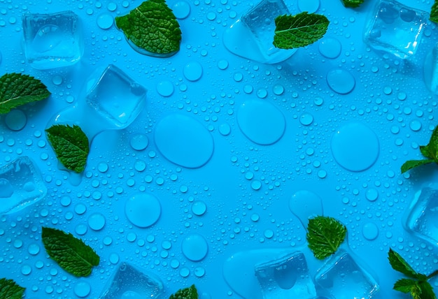 Ice cubes and mint on a blue background Selective focus