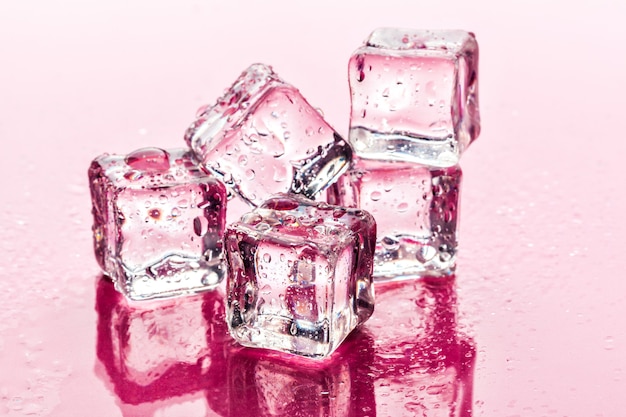 Ice cubes on pink surface