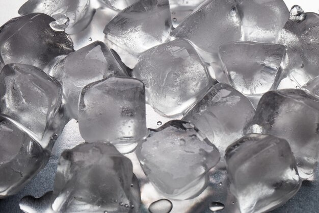 Ice cubes on a reflecting table with drops of water