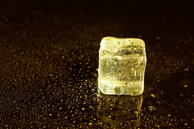 Ice cubes on reflections yellow light.