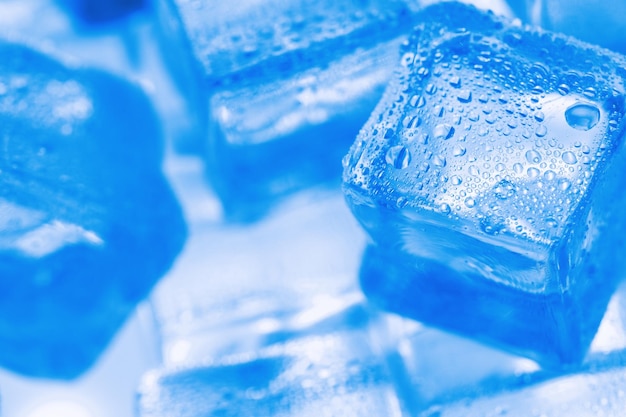 Ice cubes with blue backlight in the freezer closeup in full screen