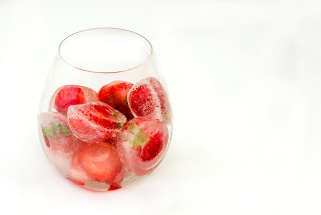 Ice cubes with frozen strawberries