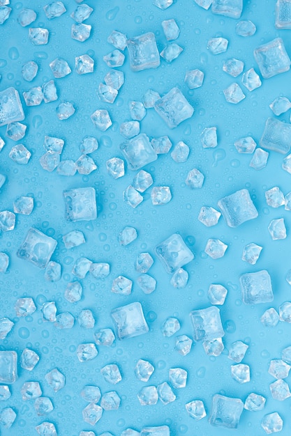 Ice cubes and with water drops scattered on blue