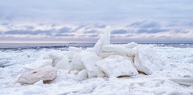 Ice floe breaking up against shore with sea ice during freezing winter weather. shelf ice.