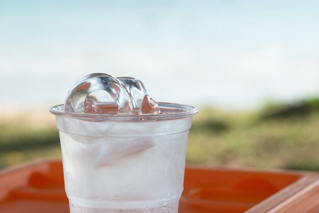 Ice in a glass of water and natural background