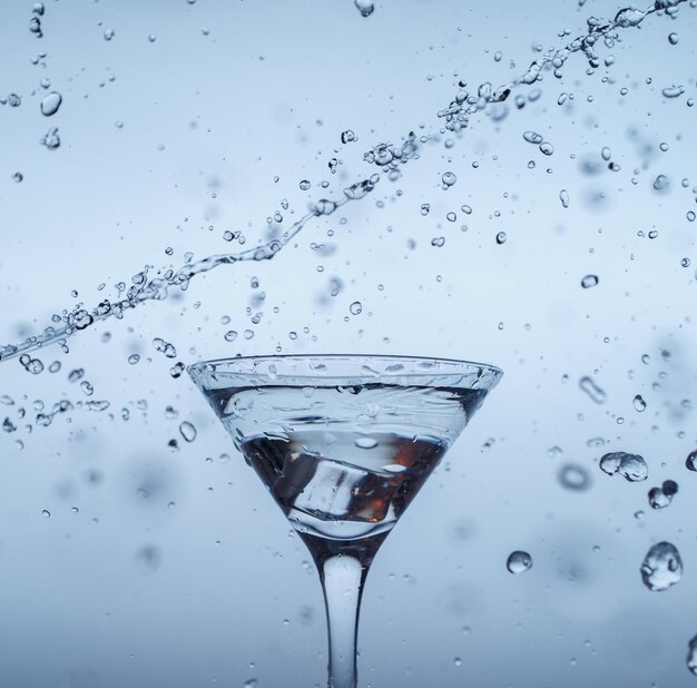 Ice in glass with water splash