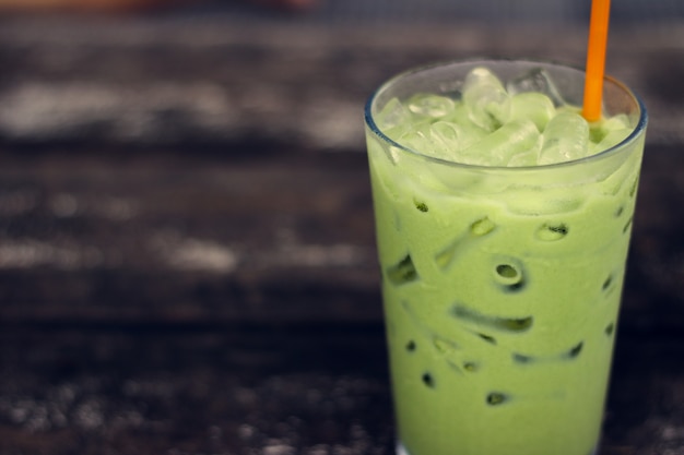 Ice green tea in glass on wood table