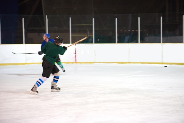 ice hockey player in action kicking with stick