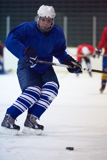 Ice hockey player in action kicking with stick