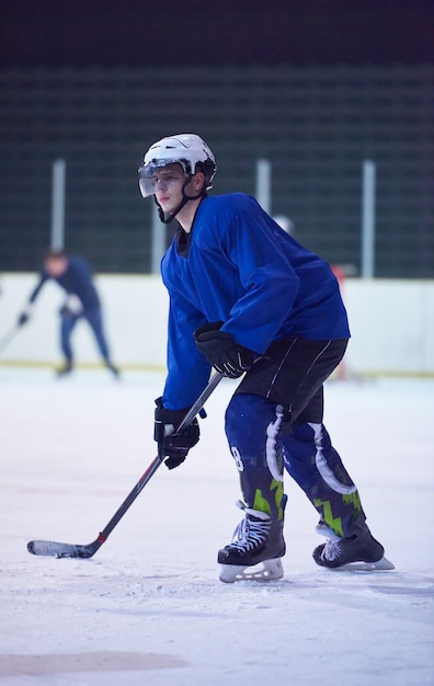 Ice hockey player in action kicking with stick