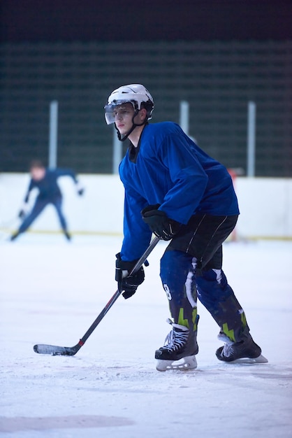 Ice hockey player in action kicking with stick