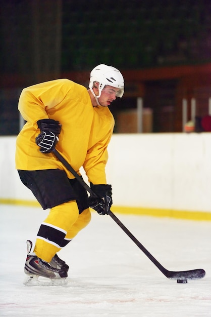 ice hockey player in action kicking with stick