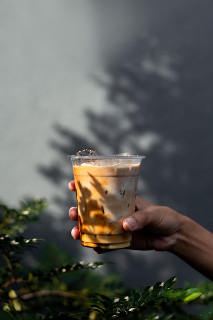 ice latte coffee in plastic glass on black table at cafe