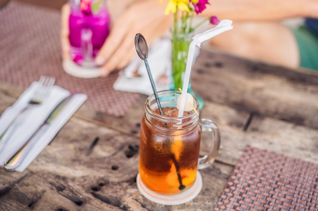 Ice lychee tea in mason jar in the cafe