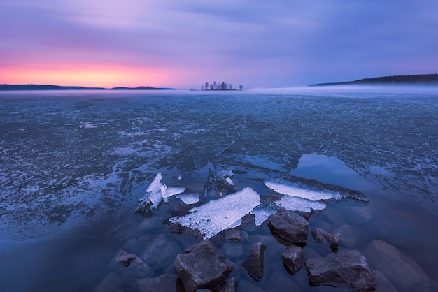 Ice melting on the lake in the sunset