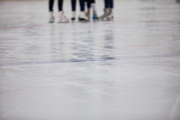 Ice ring background, closep. Winter sports skating. Figure skater and hockey player