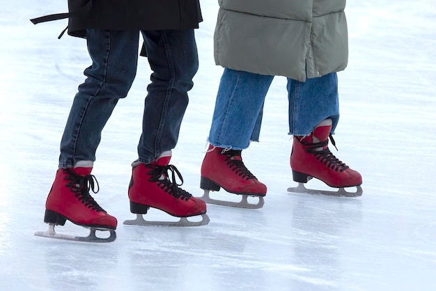 ice skating on an ice rink. legs with skates. winter active sport and leisure hobby.