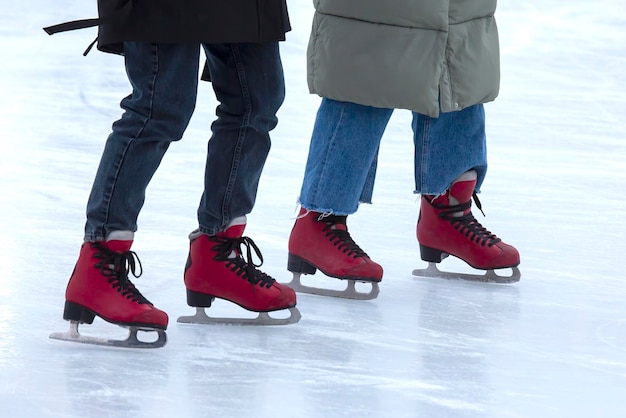 Ice skating on an ice rink. legs with skates. Winter active sport and leisure hobby.