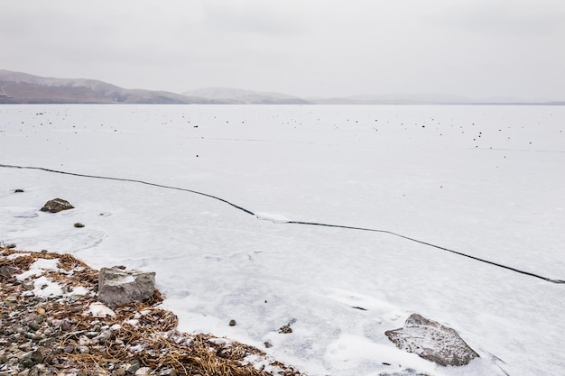 Ice and snow on the lake. Beautiful winter landscape