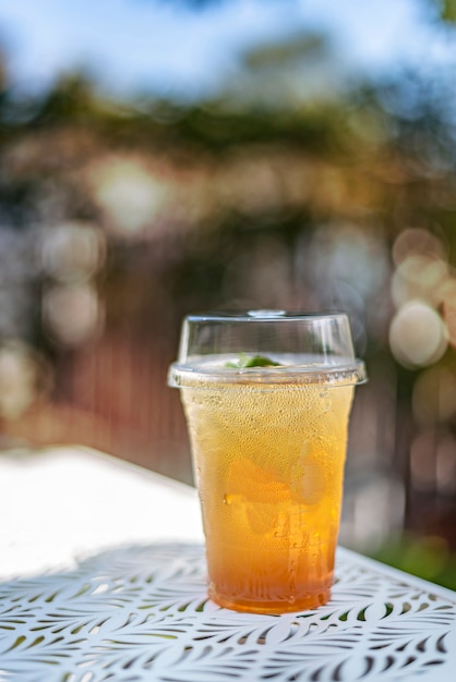 Ice tea in plastic cup put on table