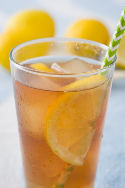 Ice tea with lemon on a beach towel