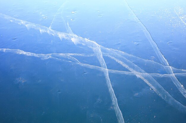 Ice texture cracks baikal, abstract background winter ice transparent blue