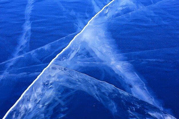 Ice texture cracks baikal, abstract background winter ice transparent blue