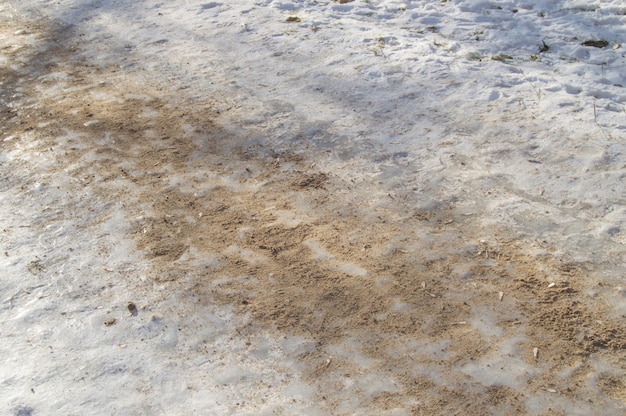 Ice track, sanded, removes ice, slippery road, close-up