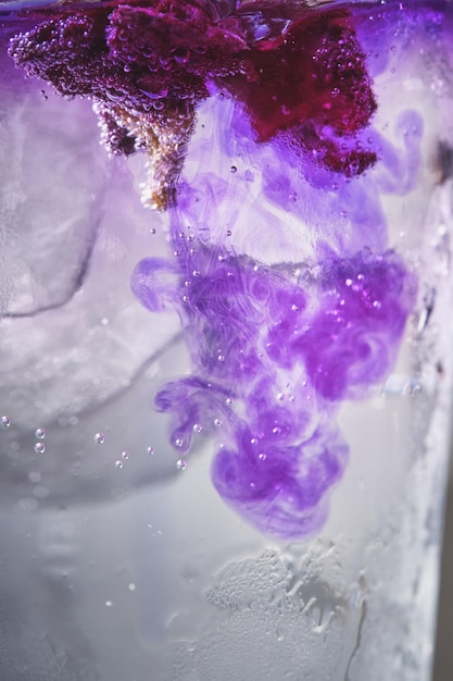 Ice with lilac colored tonic