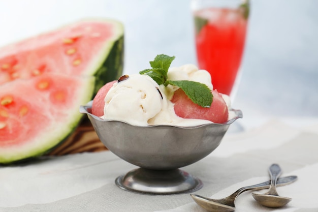 Icecream with watermelon and cocktail on light background