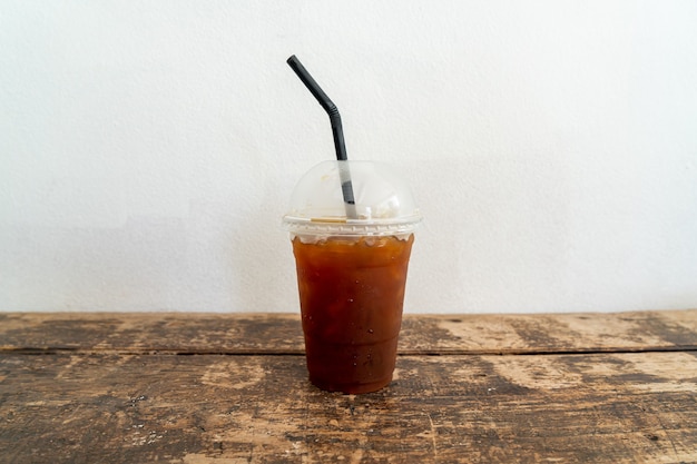 iced americano black coffee glass on wood table