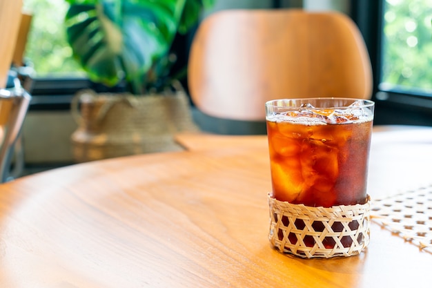 Iced americano coffee glass in coffee shop