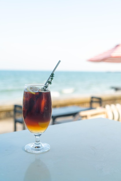 Iced americano coffee peach with sea background