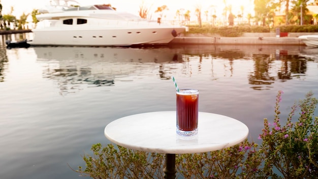 Iced americano on table Aspat marina background