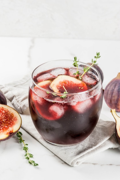 Iced autumn cocktail with red wine, thyme and figs