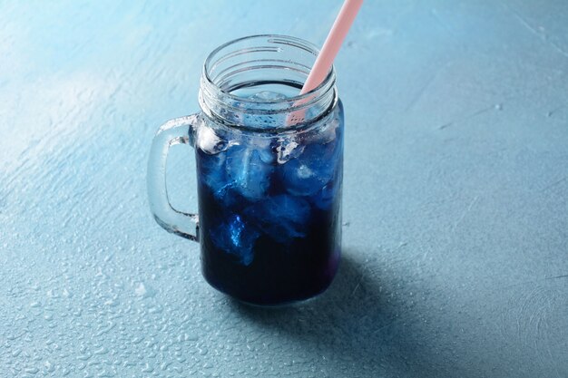 Iced butterfly pea latte. Healthy summer cold beverage, iced organic blue and violet butterfly pea flower tea