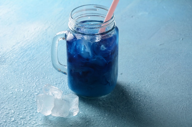 Iced butterfly pea latte. Healthy summer cold beverage, iced organic blue and violet butterfly pea flower tea