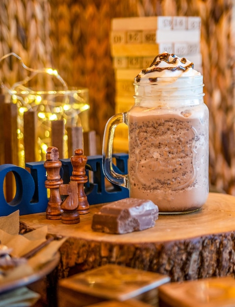 Iced chocolate frappe served in mug isolated on table side view