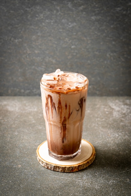 Iced chocolate milkshake drink on wood slice